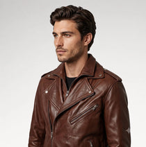 A man wearing a brown leather motorcycle jacket, photographed from the chest up against a light gray studio background.