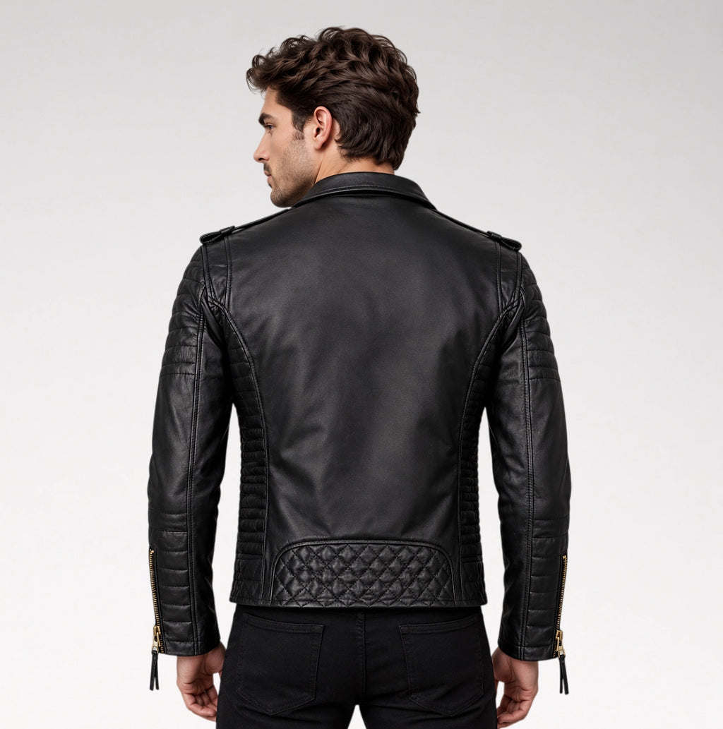 A man viewed from the back wearing a black leather biker jacket with quilted paneling and gold-tone zipper details on a light gray studio background.