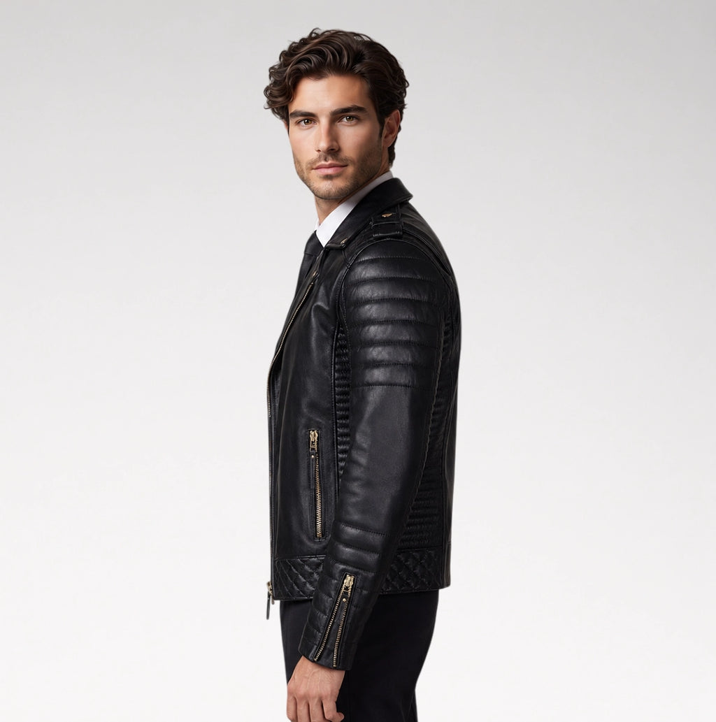 A man wearing a black leather biker jacket with quilted side panels and gold-tone zippers, shown in profile against a light gray studio background.