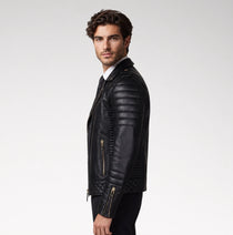A man wearing a black leather biker jacket with quilted side panels and gold-tone zippers, shown in profile against a light gray studio background.