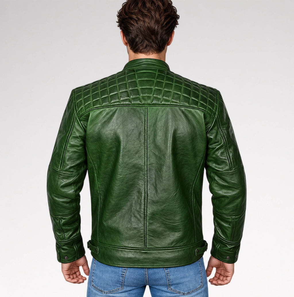 A man viewed from the back wearing a dark green leather jacket with quilted shoulder panels and blue jeans, set against a plain light gray studio background.