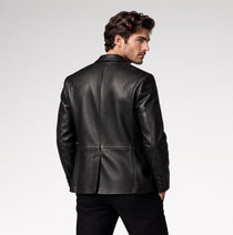 A man wearing a black leather blazer, shown from the back and three-quarter side view against a light gray studio background.