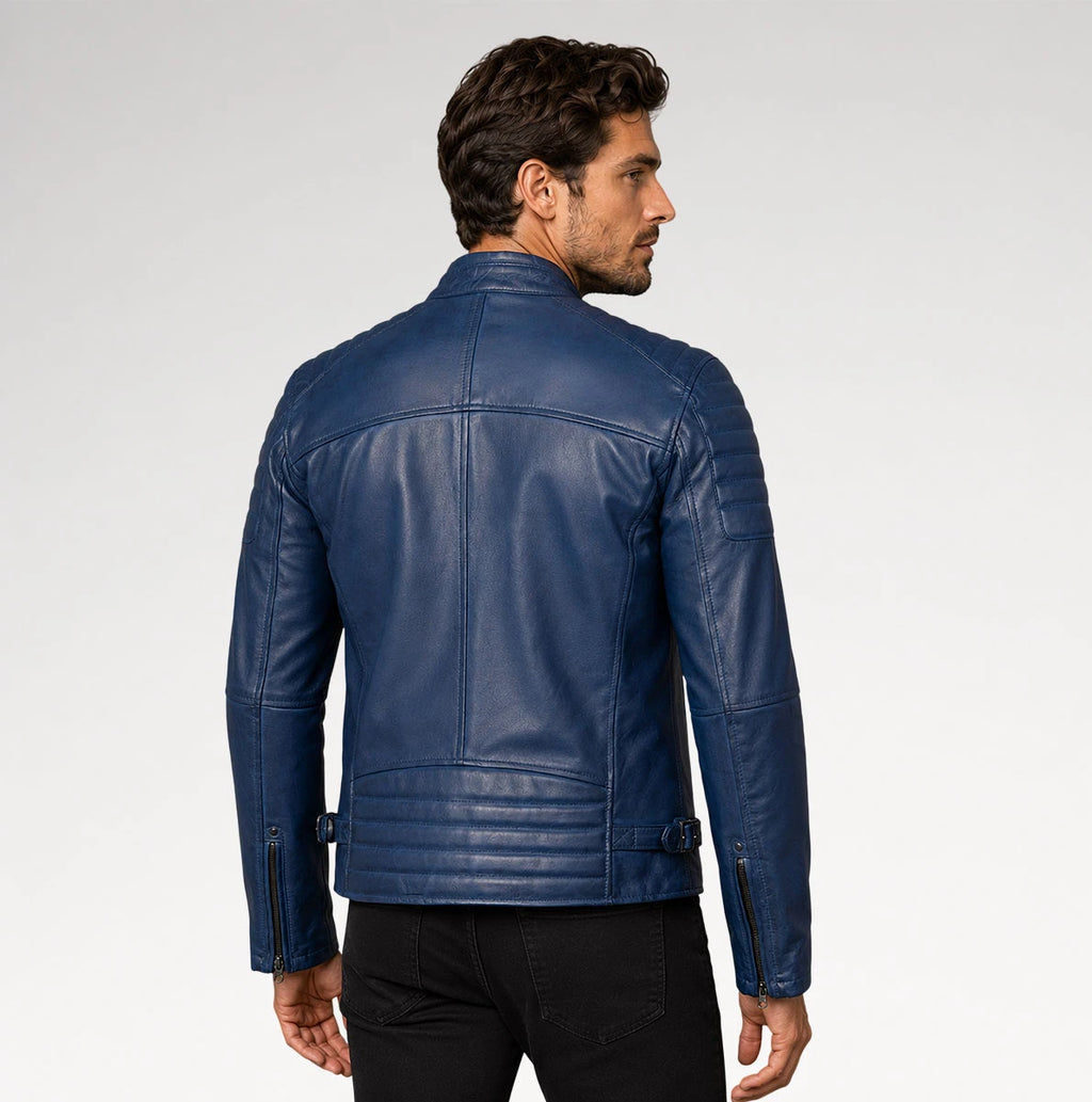 A man wearing a dark blue leather biker jacket, shown from the back and side profile against a light gray studio background.