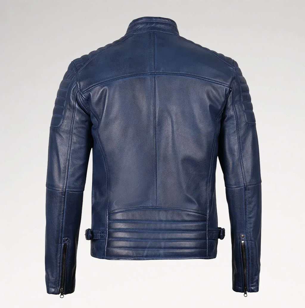 A navy blue leather jacket shown from the back, featuring quilted shoulder panels, a high collar, and zippered sleeve details, photographed against a light gray studio background.