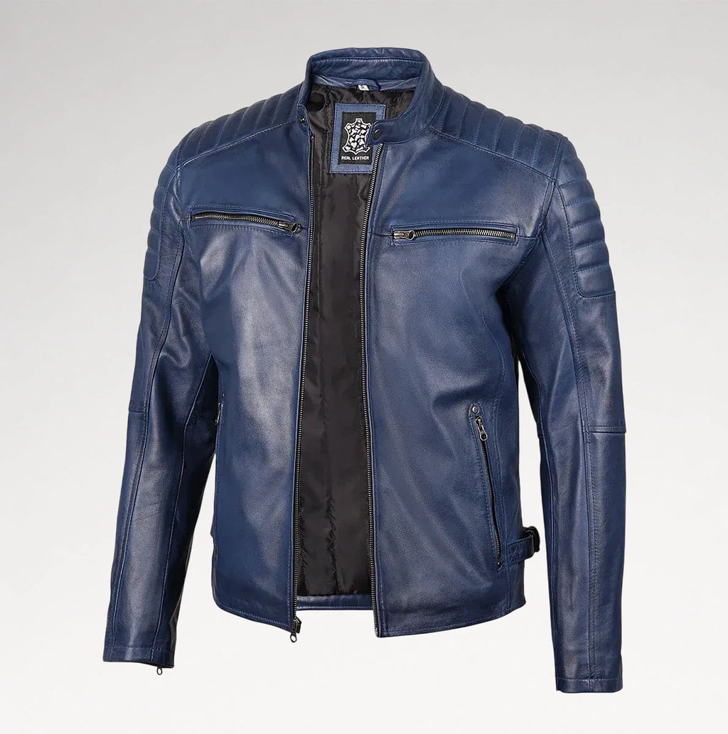 A blue leather motorcycle jacket with quilted shoulder panels, zippered chest pockets, and a black interior lining, shown on a light gray background.