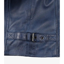 Close-up of a navy blue leather belt with a silver metal buckle and eyelets, attached to a matching leather strap on a dark leather surface.