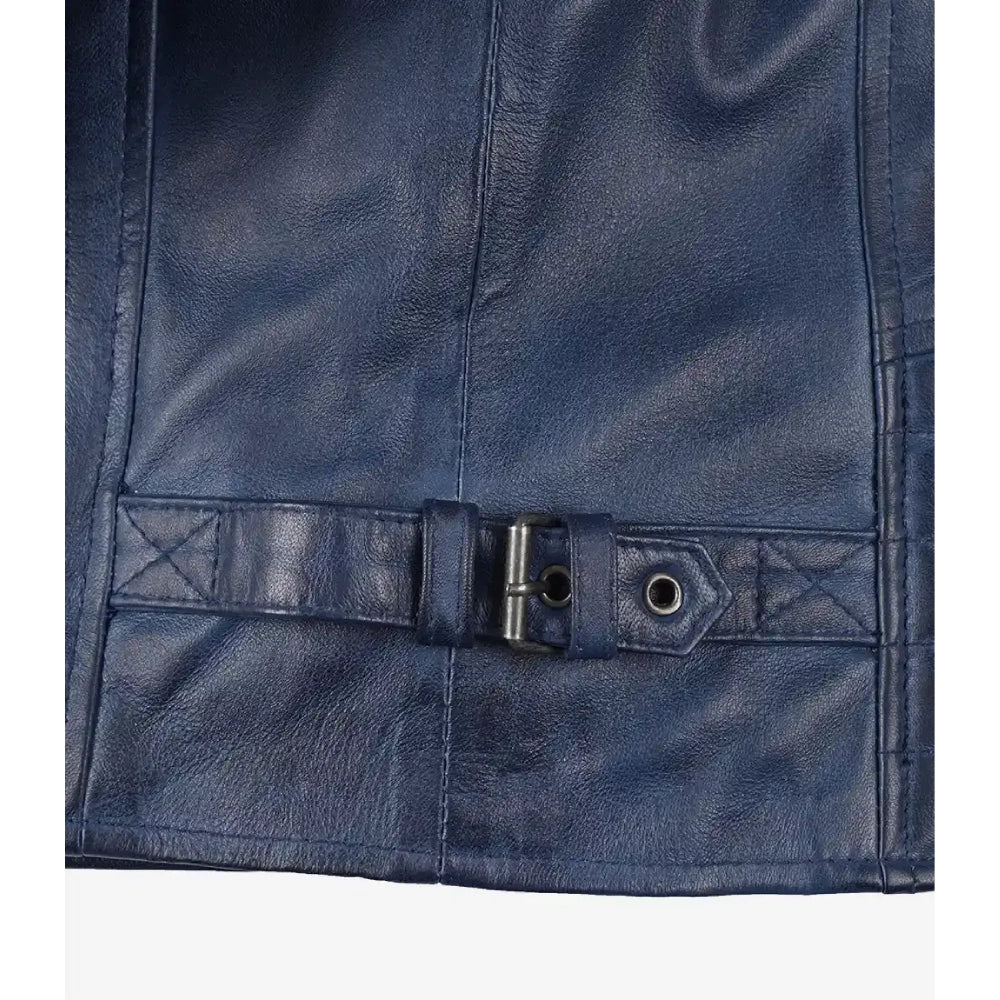 Close-up of a navy blue leather belt with a silver metal buckle and eyelets, attached to a matching leather strap on a dark leather surface.