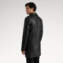 A man wearing a black leather jacket, shown from a three-quarters back view against a light gray studio background.