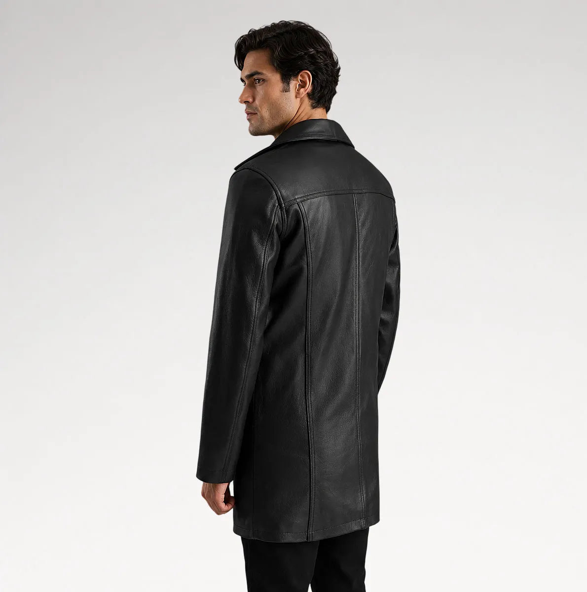 A man wearing a black leather jacket, shown from a three-quarters back view against a light gray studio background.