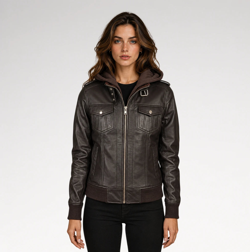 A woman modeling a dark brown faux-leather hooded jacket with silver-tone hardware, photographed against a light gray studio background.