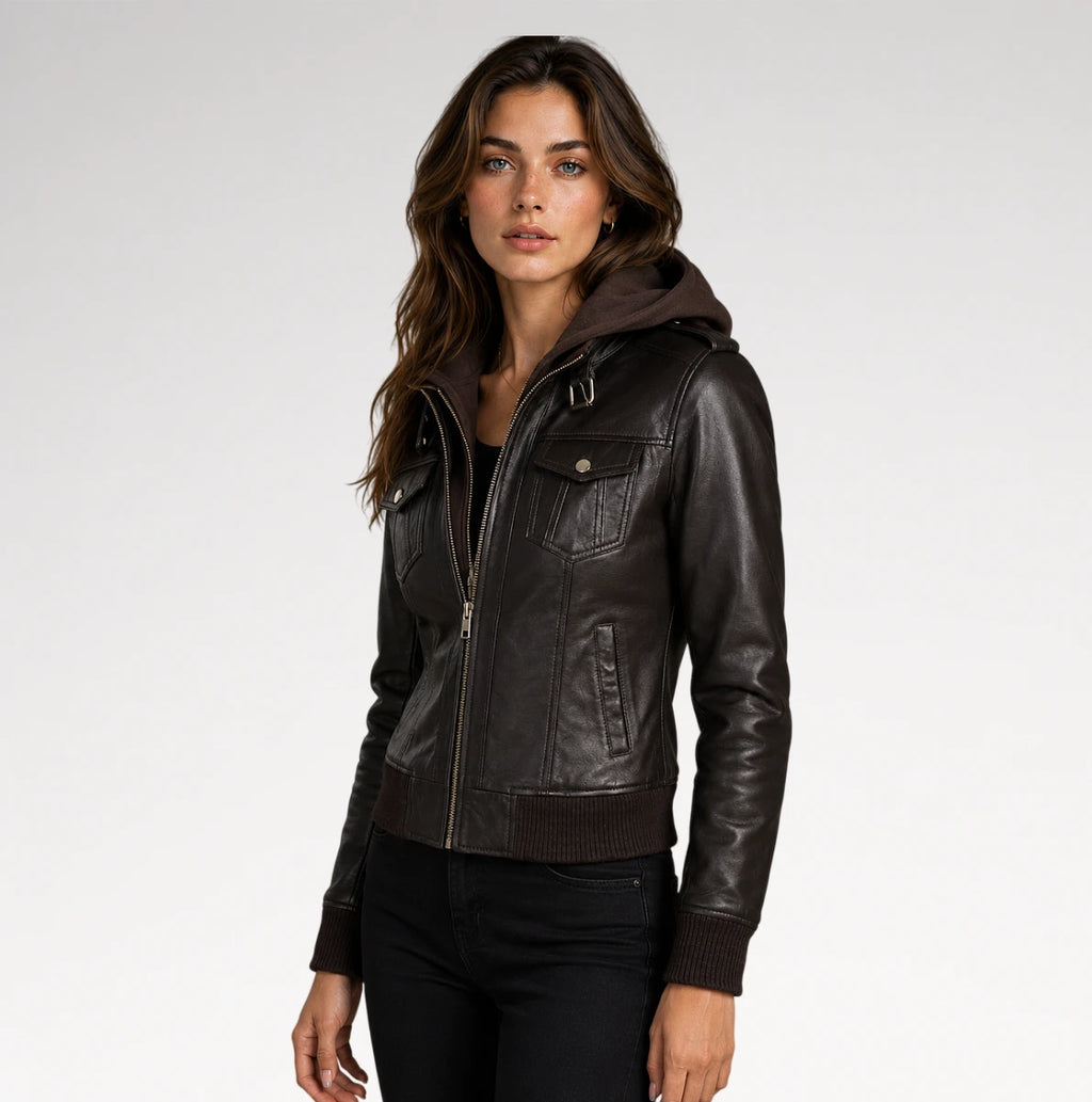 A woman wearing a dark brown faux-leather hooded jacket with ribbed knit trim, photographed against a light gray studio background.
