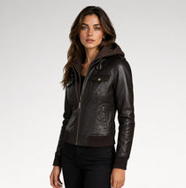 A woman wearing a dark brown faux-leather hooded jacket with ribbed knit trim, photographed against a light gray studio background.