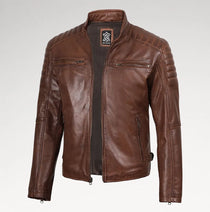 A brown leather motorcycle jacket with a stand collar, front zipper, and zippered chest pockets, displayed on a light gray background.