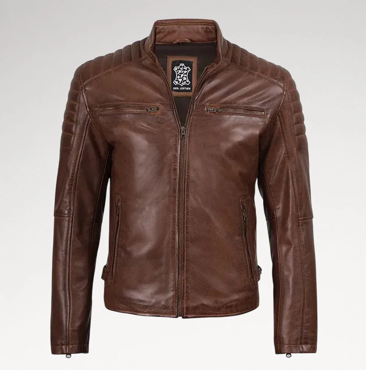 A brown leather jacket with a full zip front, stand-up collar, and quilted shoulder panels, shown on a light gray background.