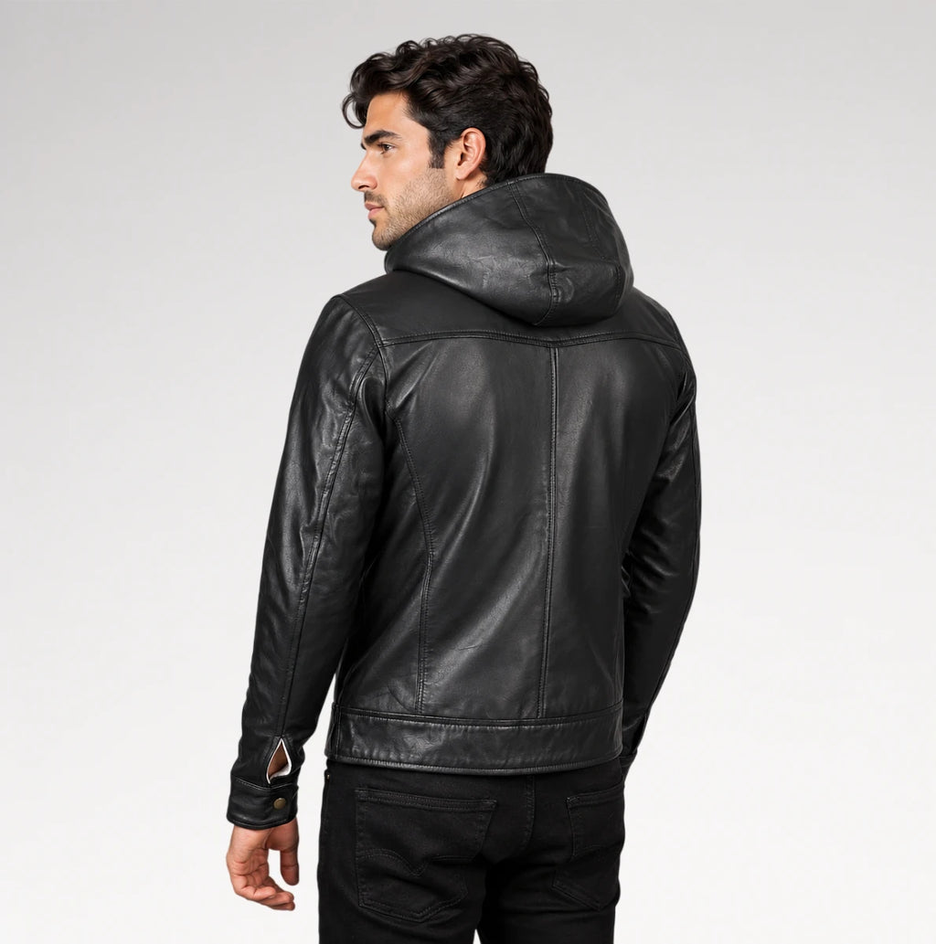 A man wearing a black leather hooded jacket, shown from a rear three-quarter angle against a light gray studio background.