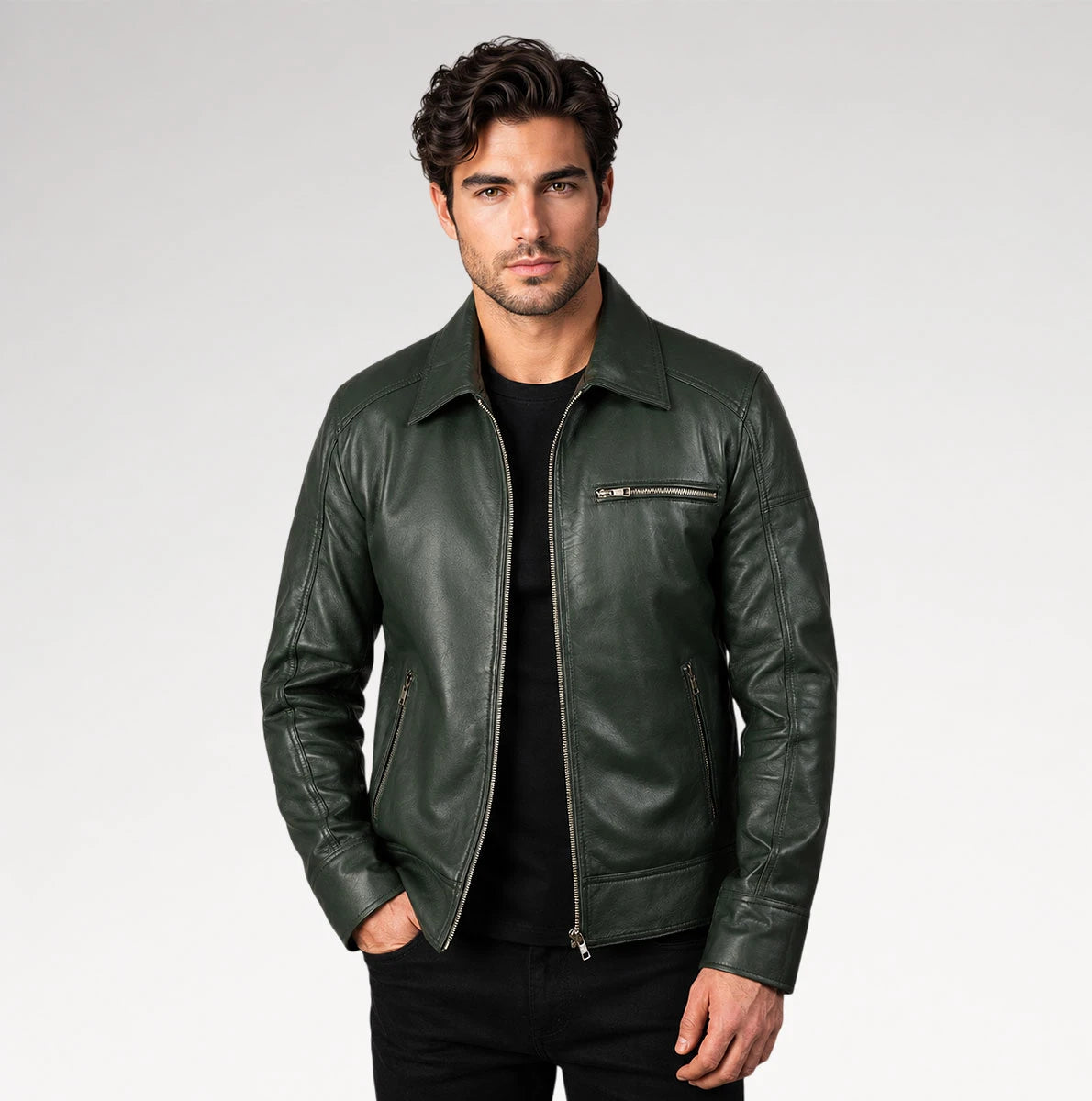 A man wearing a dark green leather jacket over a black t-shirt and black pants, standing against a light gray studio background. Main image