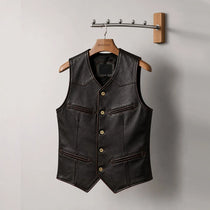 Black leather vest on a wooden hanger against a gray background