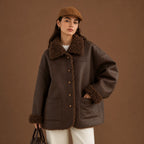 Woman wearing a brown coat with fur trim against a brown background