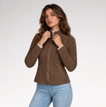 A women is wearing dark brown suede leather jacket with front pose in a grey background.
