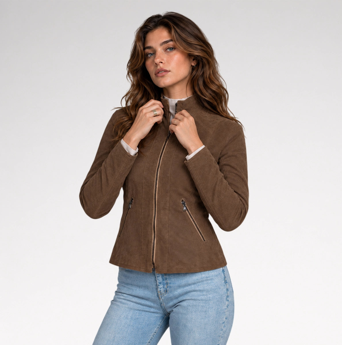 A women is wearing dark brown suede leather jacket with front pose in a grey background.
