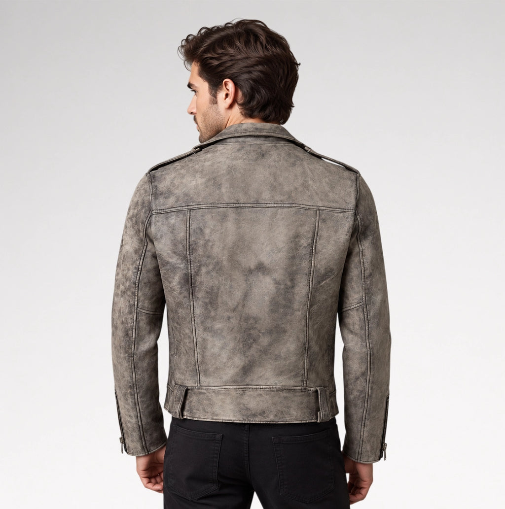 A man viewed from the back wearing a distressed gray leather jacket with shoulder epaulets and black pants, set against a plain light gray studio background.