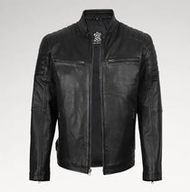 A black leather motorcycle jacket with quilted shoulder panels, a stand collar, and zippered chest pockets, shown against a light gray background.