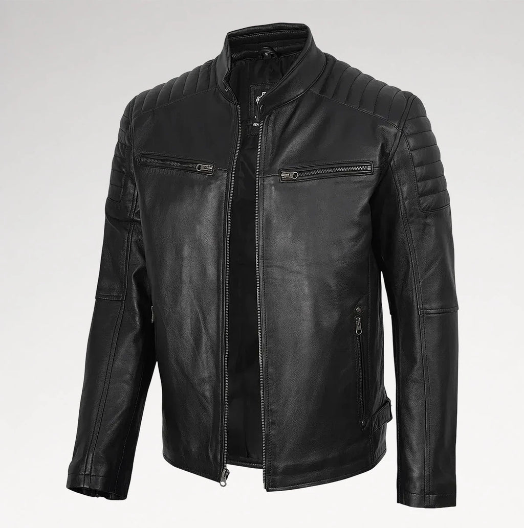 A black faux leather motorcycle jacket with a stand collar, quilted shoulder panels, and zippered chest pockets, shown on a light gray background.