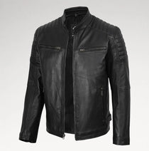 A black faux leather motorcycle jacket with a stand collar, quilted shoulder panels, and zippered chest pockets, shown on a light gray background.