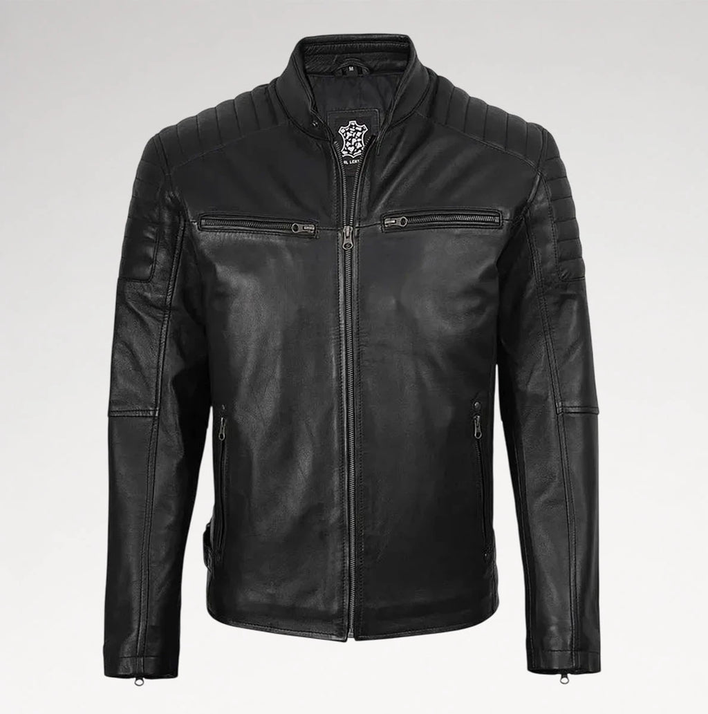 A black leather motorcycle jacket with a stand collar, quilted shoulder panels, zippered chest pockets, and a silver-toned decorative emblem on the collar, shown against a light gray background.