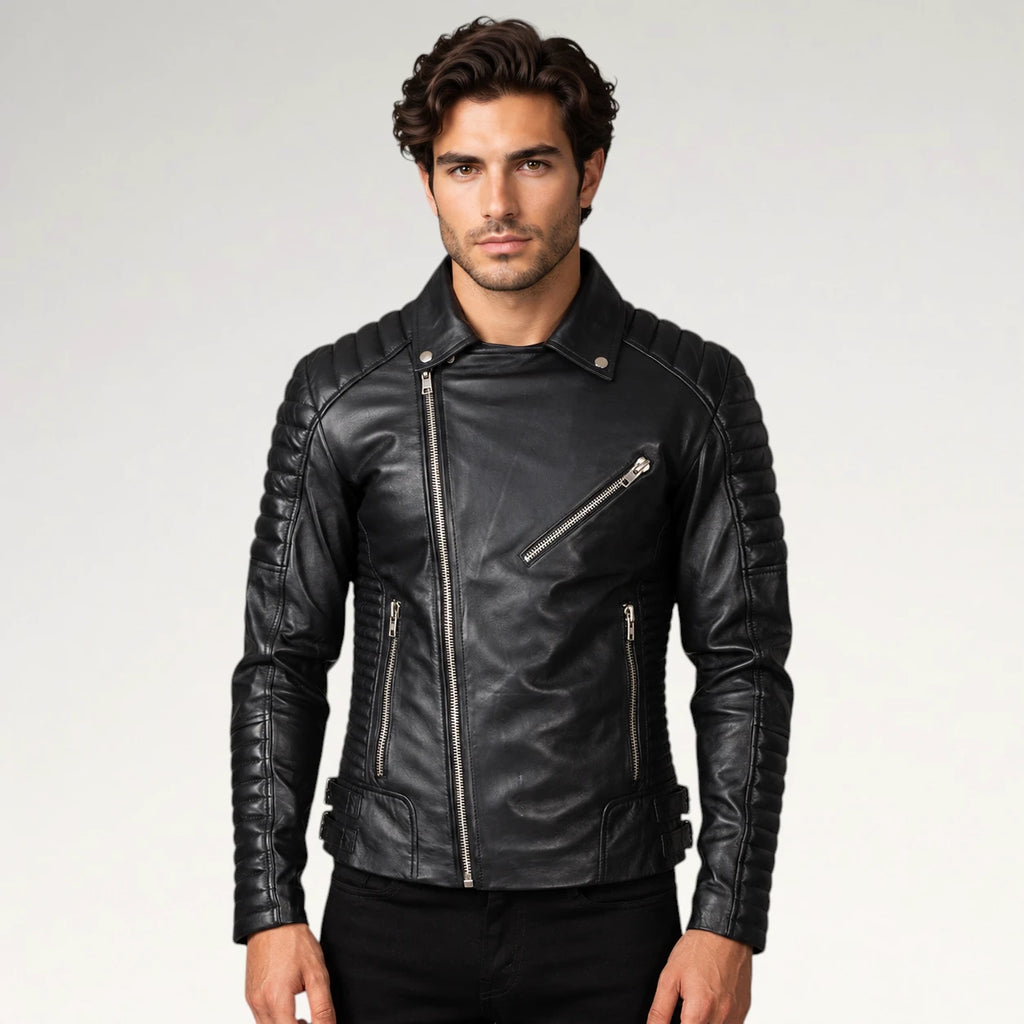 A man wearing a black leather biker jacket with silver zippers, photographed against a light gray studio background.