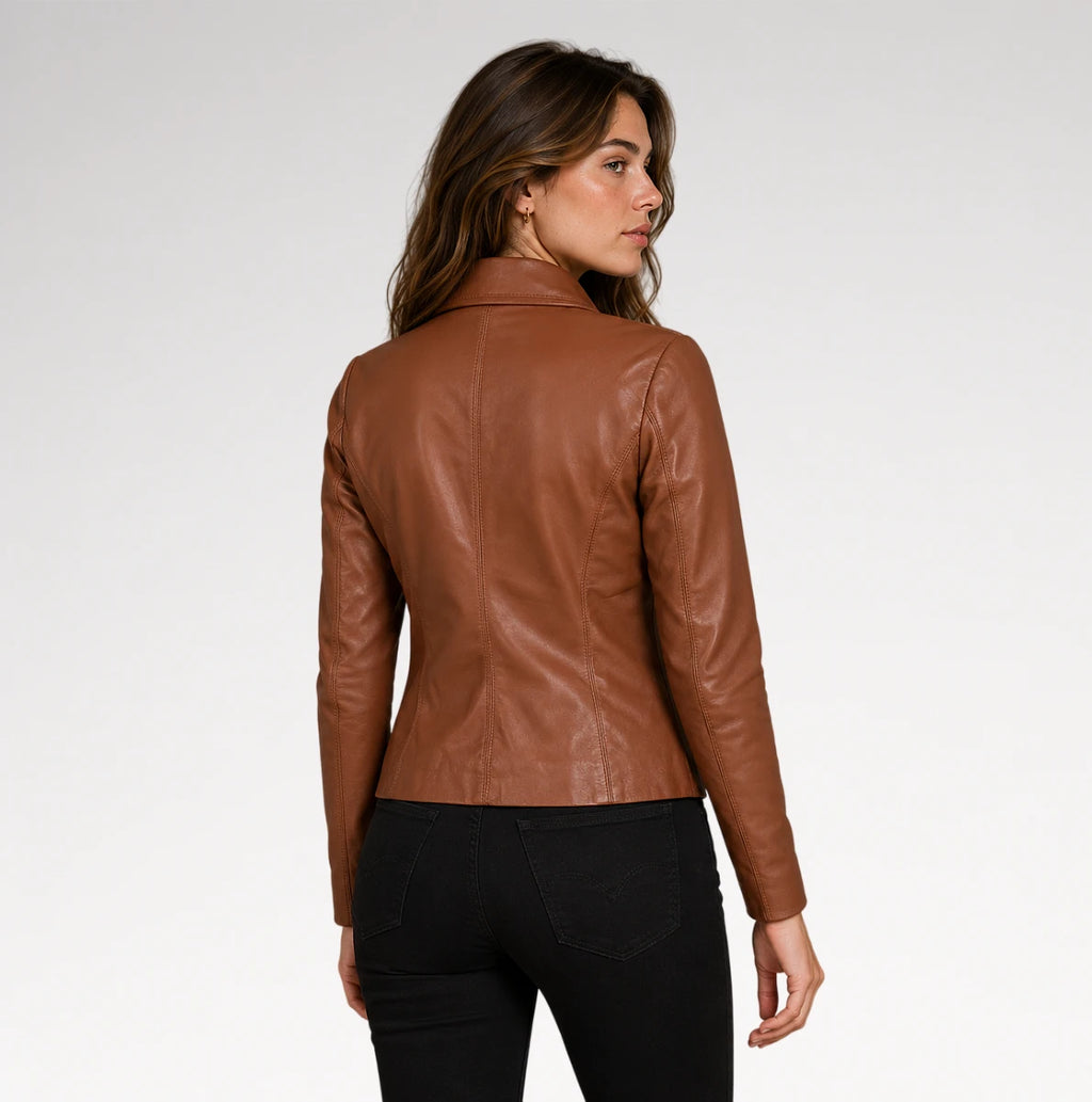 A woman shown from the back wearing a fitted brown faux-leather jacket and black pants against a plain light gray studio background.