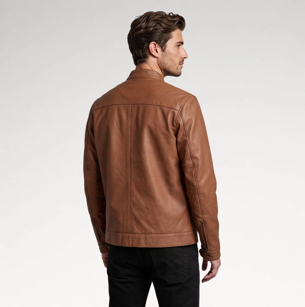 A man wearing a brown leather jacket, shown from the back and side profile against a light gray studio background.