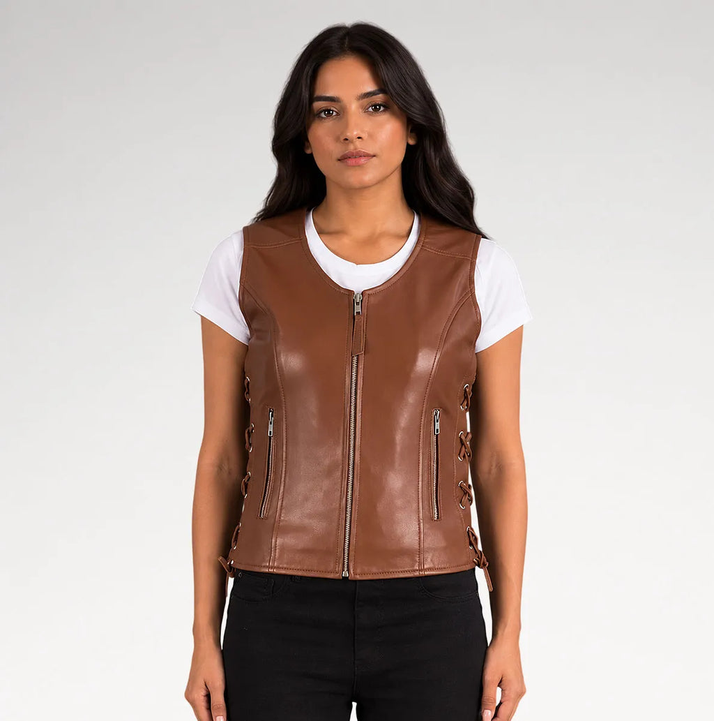 A woman modeling a brown faux-leather zip-front vest over a white t-shirt and black pants, photographed against a light gray studio background.