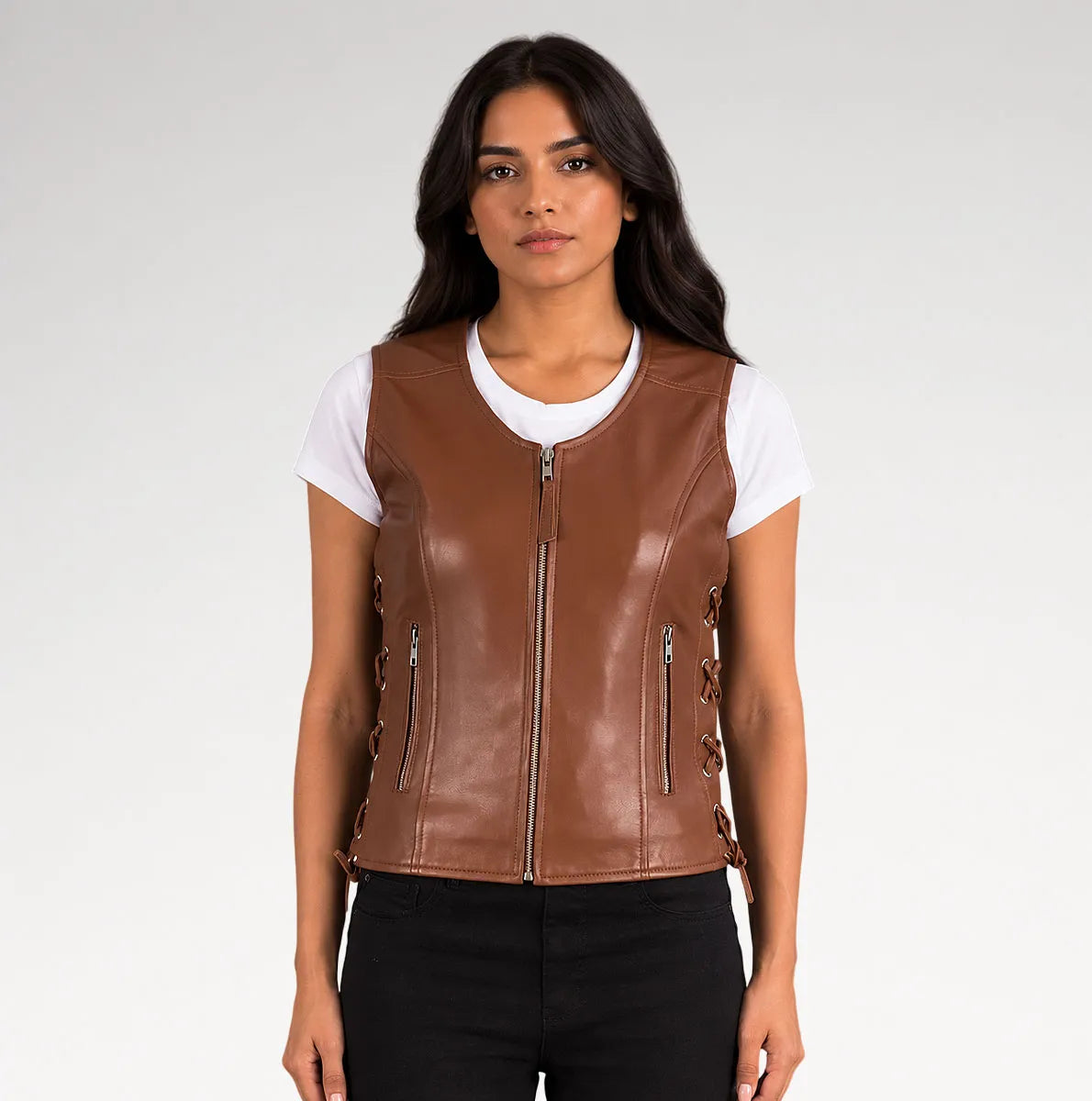 A woman modeling a brown faux-leather zip-front vest over a white t-shirt and black pants, photographed against a light gray studio background. Main image