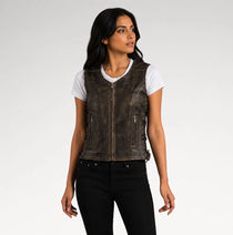 A woman modeling a dark brown distressed leather motorcycle vest over a white t-shirt and black jeans, photographed against a light gray studio background.