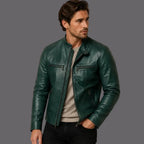 Man wearing a green leather jacket against a neutral background