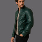 Man wearing a green leather jacket against a plain background