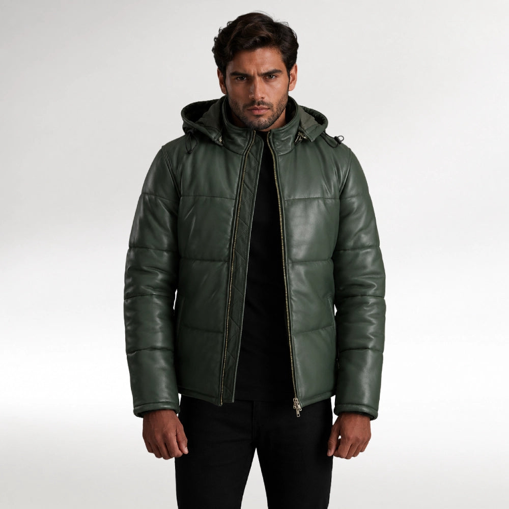 A man wearing a dark green quilted leather hooded jacket over a black shirt and black pants, standing against a light gray studio background. Main image