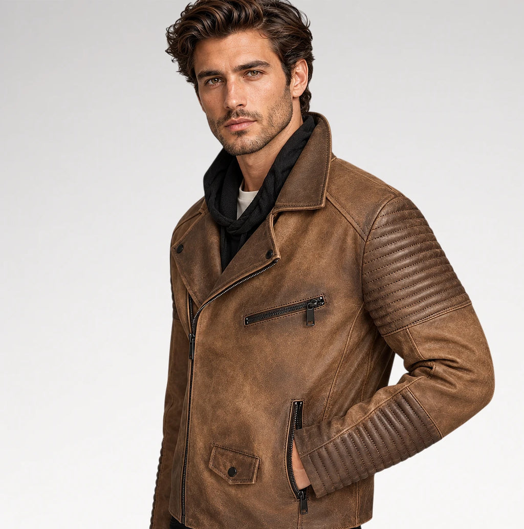A man wearing a brown faux-leather motorcycle jacket with ribbed shoulder panels and a black scarf, photographed against a light gray studio background.