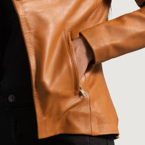 Close-up of a brown leather jacket with a blurred background
