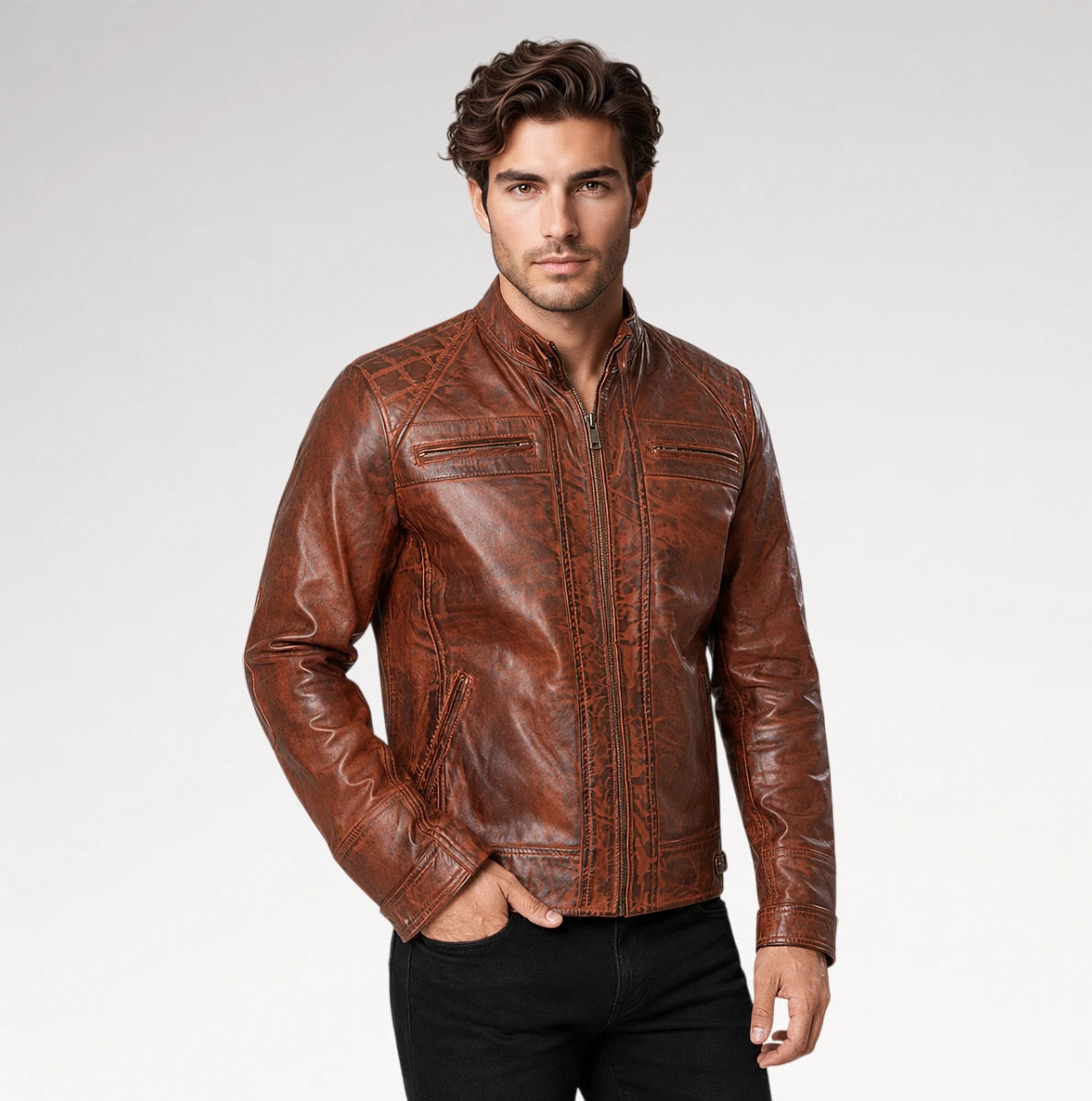 A man wearing a brown distressed leather jacket with zippered chest pockets, paired with black pants, standing against a light gray studio background. Main image