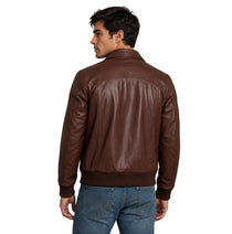 A man wearing a brown leather jacket, shown from the back, paired with blue jeans against a plain white background.
