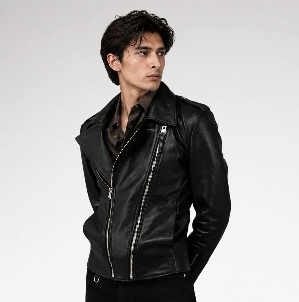 A man wearing a black leather motorcycle jacket with silver zippers, posed against a light gray studio background. Main image