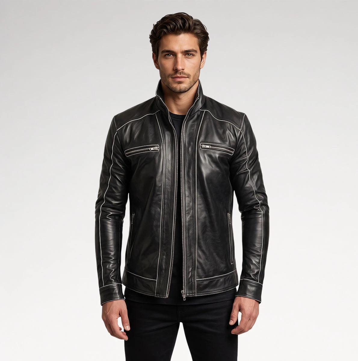 A man wearing a black leather jacket with contrasting white stitching and zippered chest pockets, photographed against a light gray studio background. Main image