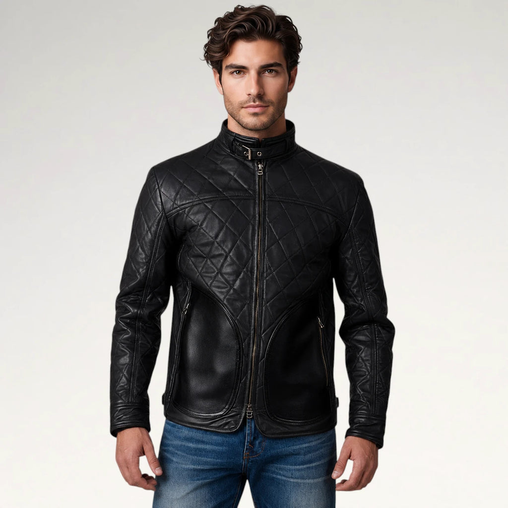 A man wearing a black quilted leather jacket with a stand-up collar and front zipper, paired with blue jeans, photographed against a light gray studio background.