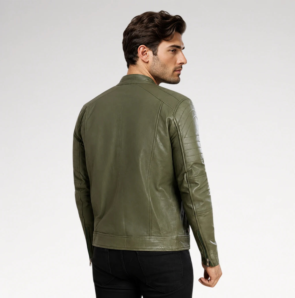A man wearing an olive green leather jacket, shown from a three-quarters back view against a light gray studio background.