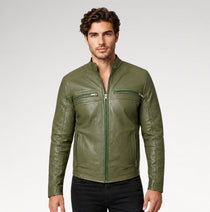 A man wearing a fitted olive green leather jacket with a front zipper, zip chest pockets, and zip hand pockets, paired with black pants, against a light gray studio background.