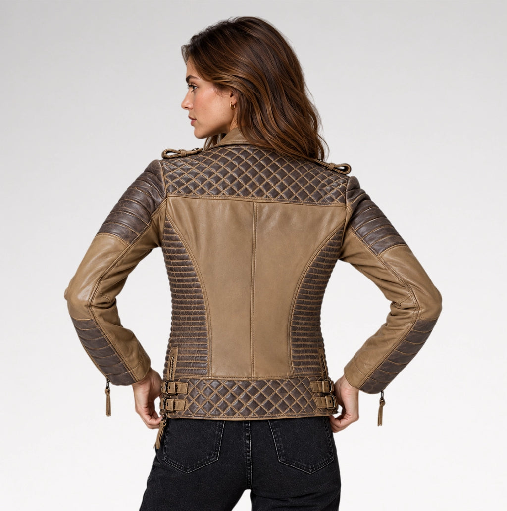 A woman shown from the back wearing a tan and dark brown faux-leather motorcycle jacket with quilted diamond-patterned panels and ribbed sleeves, paired with black jeans, against a light gray studio background.