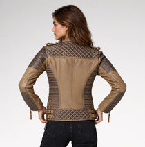 A woman shown from the back wearing a tan and dark brown faux-leather motorcycle jacket with quilted diamond-patterned panels and ribbed sleeves, paired with black jeans, against a light gray studio background.