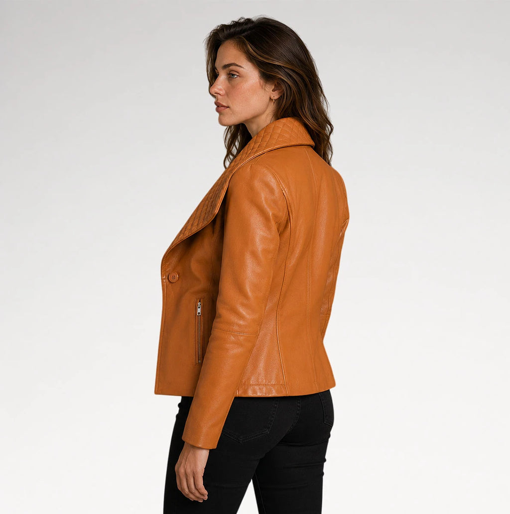 A woman shown in side profile wearing a cropped tan leather jacket with a single button closure and zippered sleeve, paired with black pants, against a plain light gray studio background.